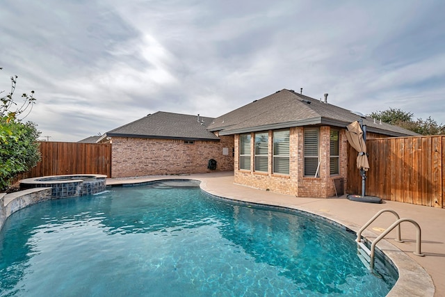 view of pool featuring an in ground hot tub and a patio