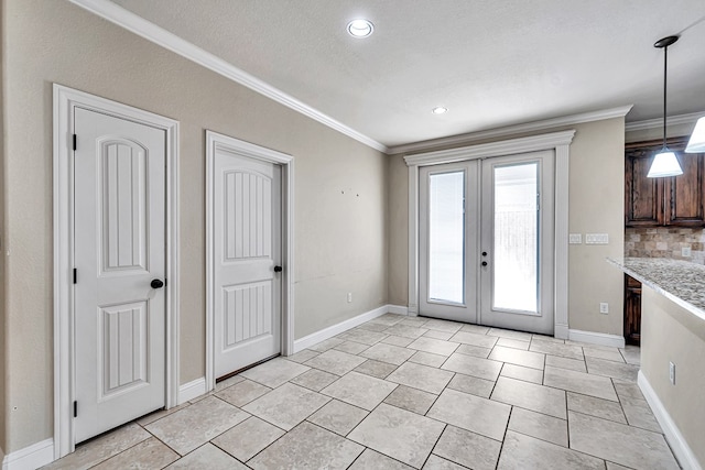 doorway to outside featuring french doors, crown molding, and a textured ceiling