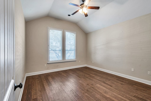 spare room with ceiling fan, lofted ceiling, and dark hardwood / wood-style flooring