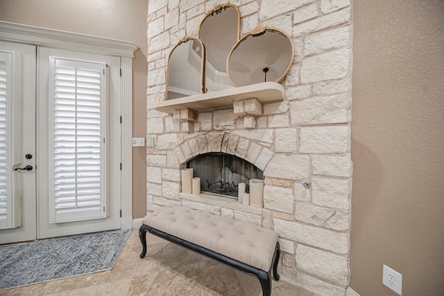 interior details with a stone fireplace