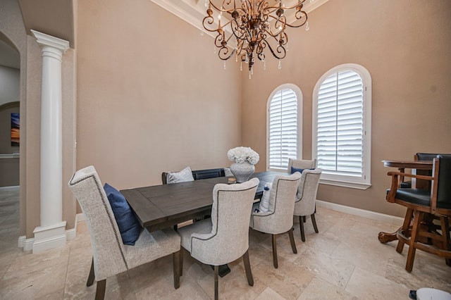 dining room with ornate columns, crown molding, a high ceiling, and a notable chandelier