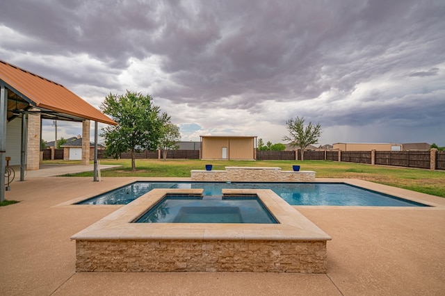 view of swimming pool featuring a lawn, a storage unit, and an in ground hot tub