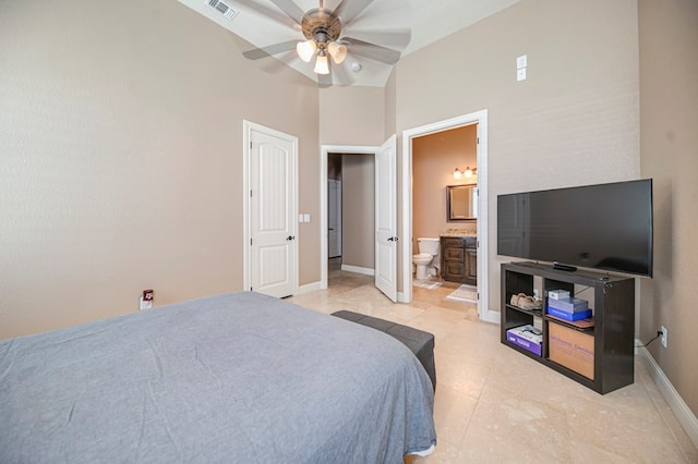 bedroom featuring ensuite bathroom, ceiling fan, and high vaulted ceiling