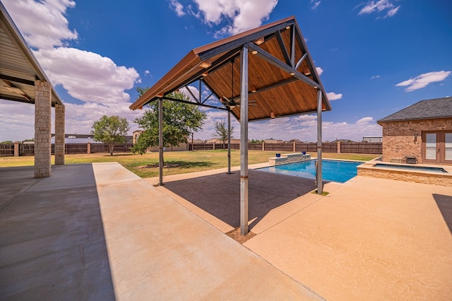 view of swimming pool featuring a patio area, an in ground hot tub, and a yard