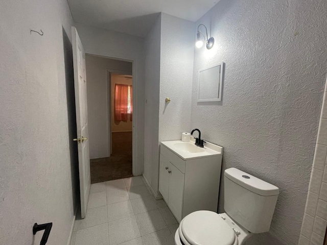 4705 Ric Dr, Midland, TX 79703 - bathroom with toilet, vanity, tile patterned floors, and a textured wall
