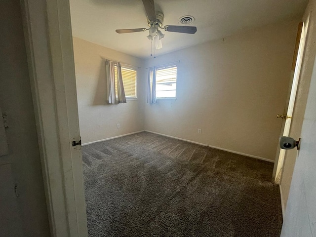 4705 Ric Dr, Midland, TX 79703 - empty room with dark carpet, a ceiling fan, and baseboards
