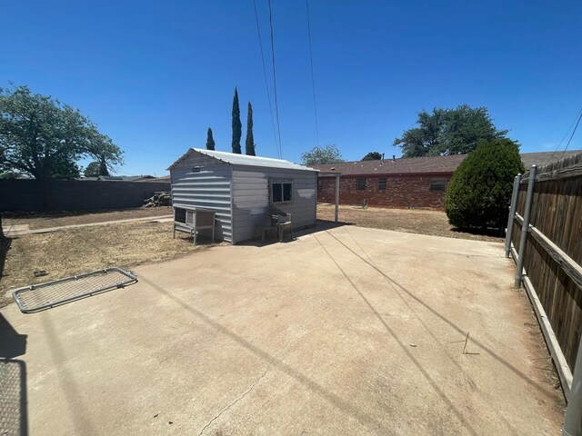 4705 Ric Dr, Midland, TX 79703 - view of patio with fence and an outbuilding