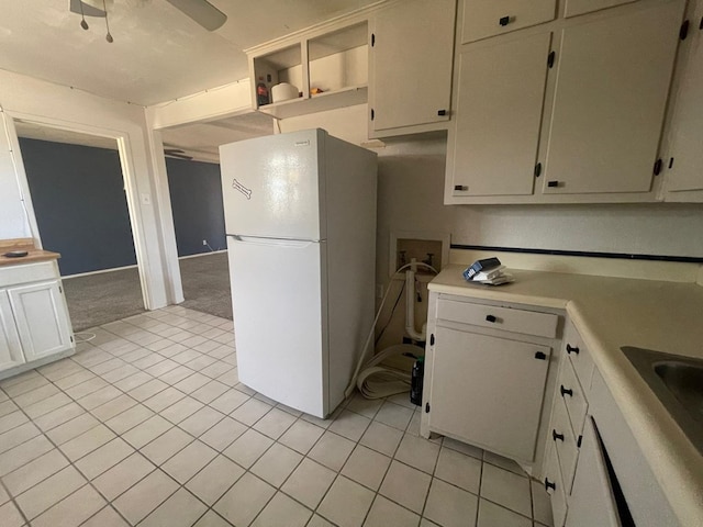 4705 Ric Dr, Midland, TX 79703 - kitchen featuring freestanding refrigerator, light countertops, light tile patterned flooring, and open shelves