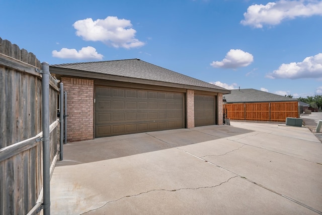 detached garage featuring fence