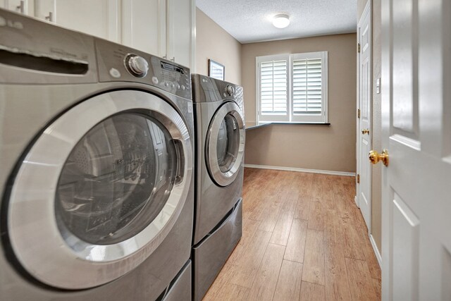 5810 Sterling Pl, Midland, TX 79707 - laundry area with washer and dryer, light wood finished floors, a textured ceiling, and baseboards