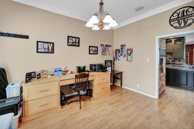 office area featuring light wood finished floors, ornamental molding, a chandelier, and baseboards