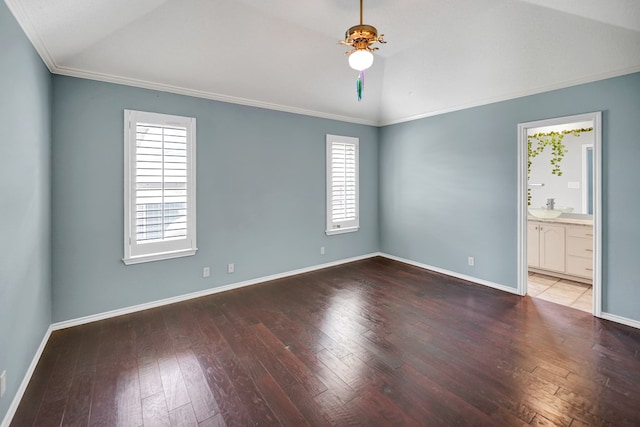 unfurnished room with lofted ceiling, a ceiling fan, wood-type flooring, baseboards, and crown molding