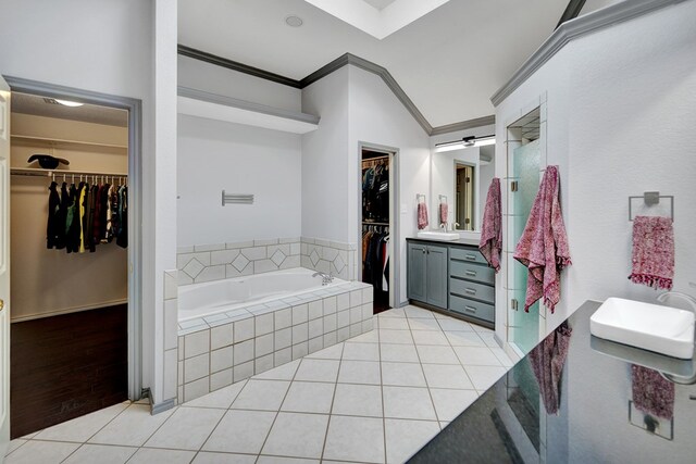 5810 Sterling Pl, Midland, TX 79707 - bathroom with ornamental molding, vanity, tile patterned flooring, a garden tub, and a walk in closet