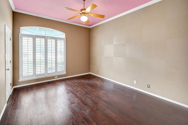 empty room featuring healthy amount of natural light, dark wood-style floors, ceiling fan, and crown molding