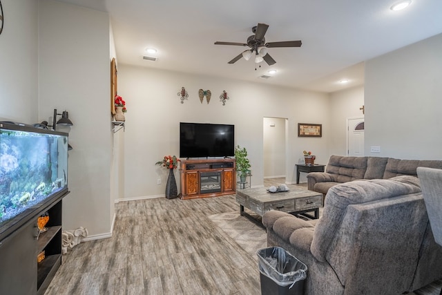 living room featuring ceiling fan and light wood-type flooring