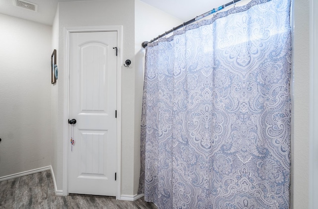 bathroom with wood-type flooring