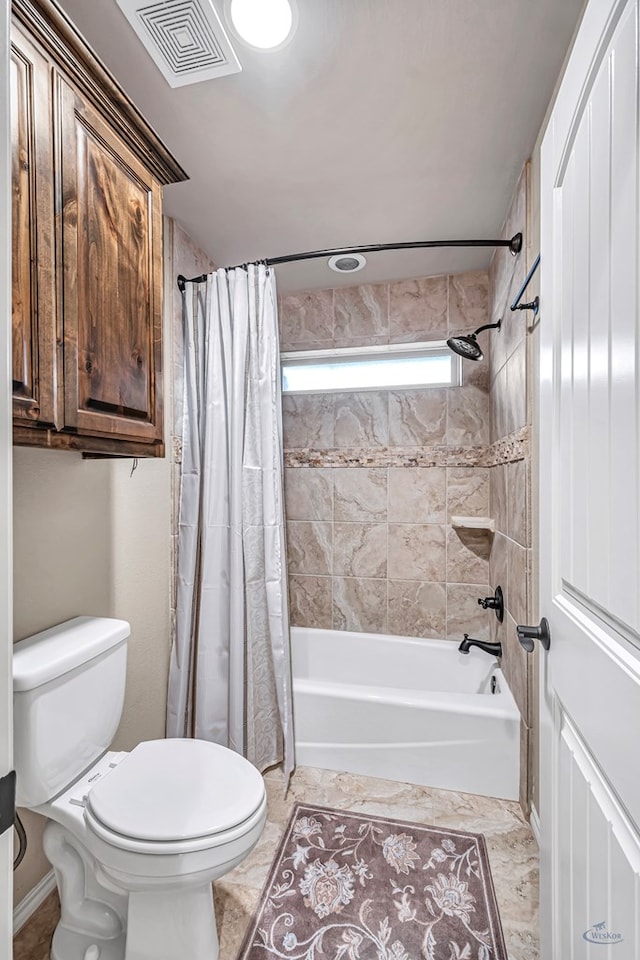 bathroom with shower / bath combo, visible vents, and toilet