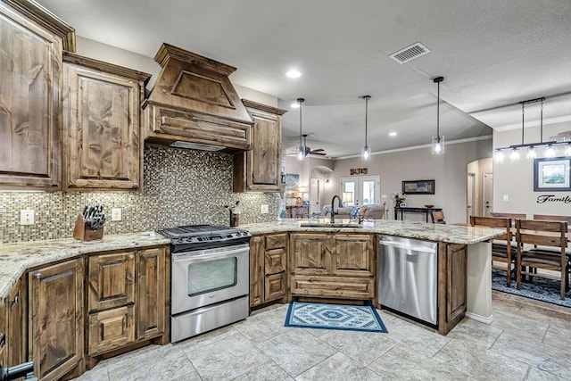 kitchen with crown molding, a sink, appliances with stainless steel finishes, visible vents, and arched walkways