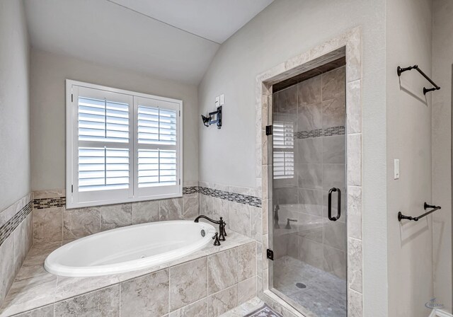 bathroom with a shower stall and a bath