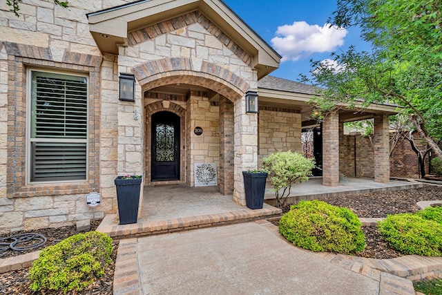 view of exterior entry featuring stone siding