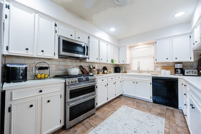 3615 W Wadley Ave, Midland, TX 79707 - kitchen featuring stainless steel appliances, healthy amount of natural light, a textured ceiling, light countertops, and tasteful backsplash