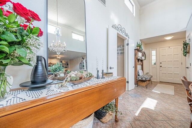 3615 W Wadley Ave, Midland, TX 79707 - foyer entrance featuring a high ceiling, a chandelier, and crown molding