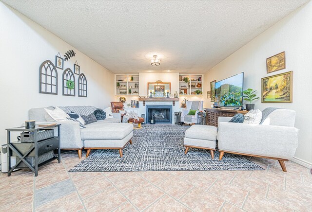 3615 W Wadley Ave, Midland, TX 79707 - living area with built in shelves, a fireplace, and a textured ceiling