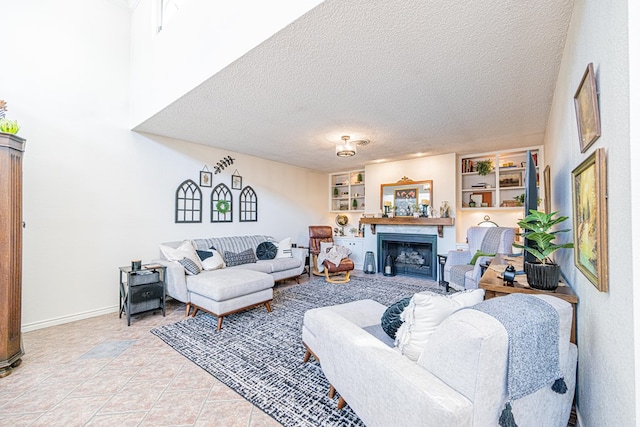 3615 W Wadley Ave, Midland, TX 79707 - living room with a fireplace, a textured ceiling, light tile patterned floors, and built in shelves