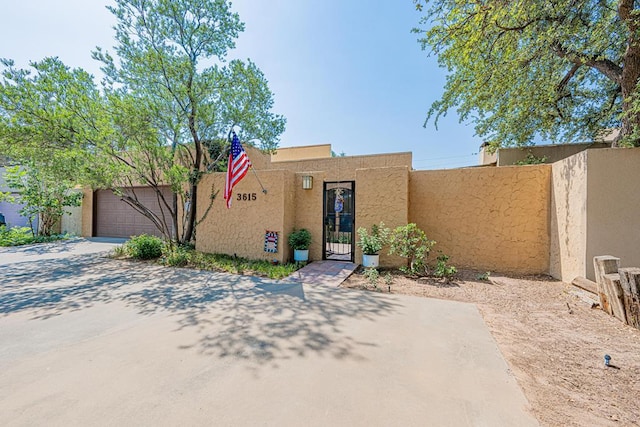 3615 W Wadley Ave, Midland, TX 79707 - adobe home featuring stucco siding, concrete driveway, and an attached garage