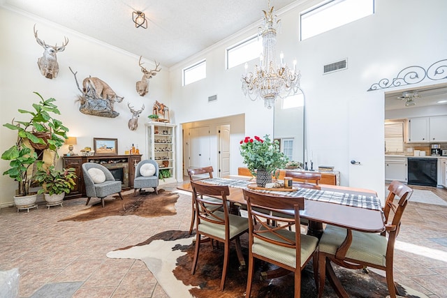 3615 W Wadley Ave, Midland, TX 79707 - dining area with ornamental molding, a chandelier, and a towering ceiling