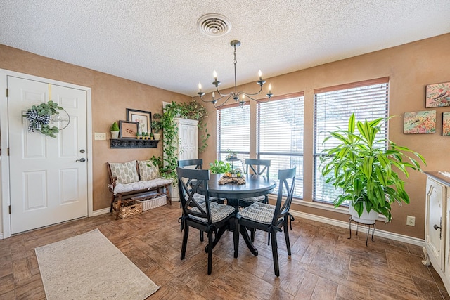 3615 W Wadley Ave, Midland, TX 79707 - dining room with a chandelier, plenty of natural light, and a textured ceiling