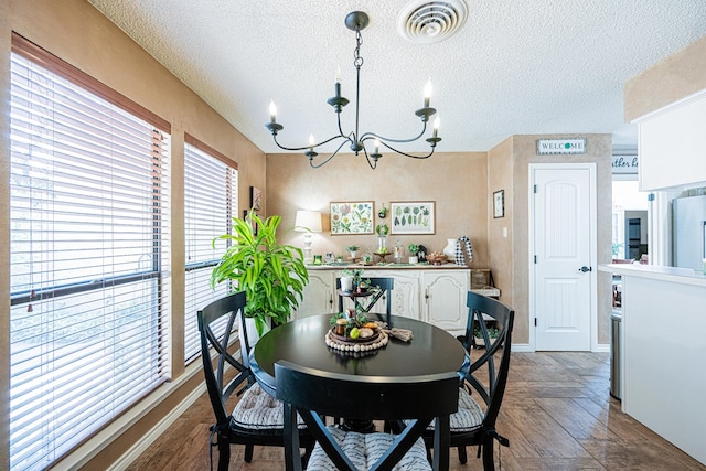 3615 W Wadley Ave, Midland, TX 79707 - dining area featuring a textured ceiling and a chandelier