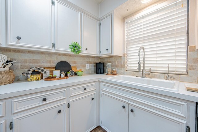 3615 W Wadley Ave, Midland, TX 79707 - kitchen featuring light countertops, white cabinets, and backsplash