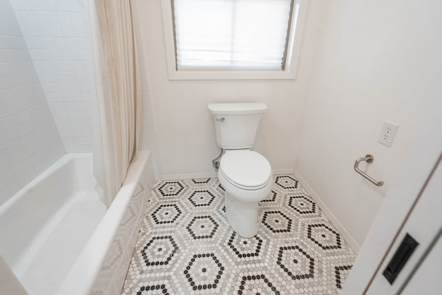 bathroom with shower / bath combo and toilet