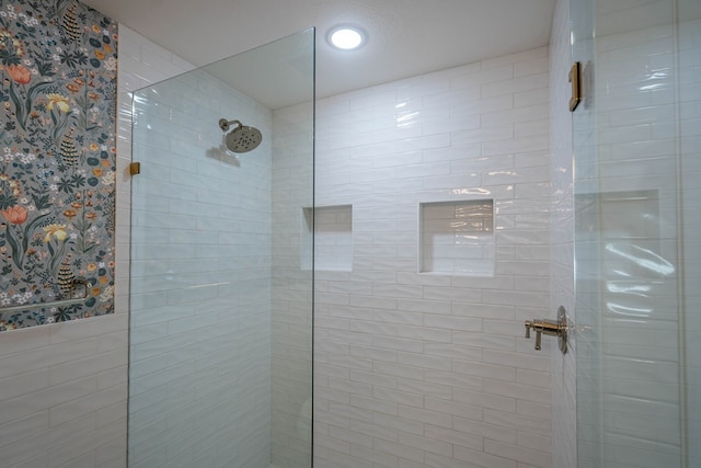 bathroom featuring a shower with door