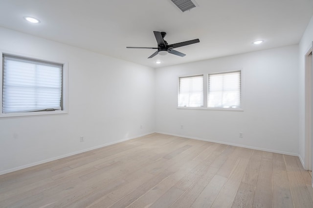 spare room with light wood-type flooring and ceiling fan