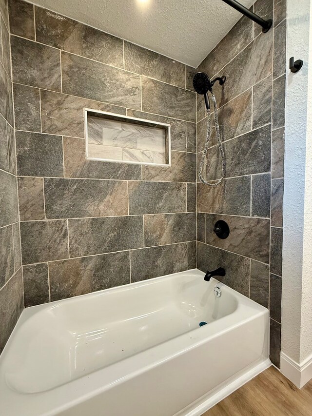 full bathroom with shower / tub combo with curtain, hardwood / wood-style flooring, vanity, a textured ceiling, and toilet