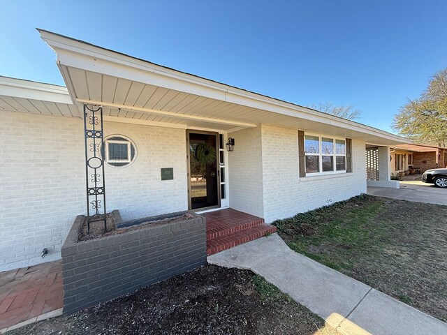 ranch-style home featuring a carport