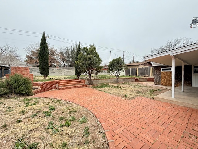 view of patio featuring fence