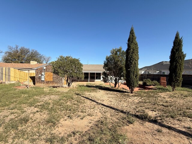 rear view of house featuring a patio and central AC