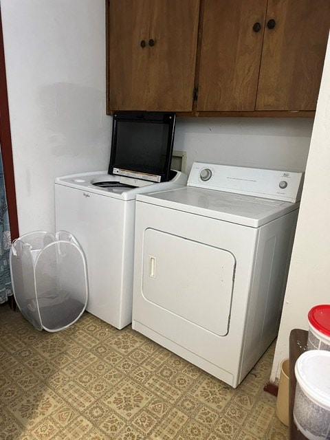 laundry area featuring cabinets and washing machine and dryer