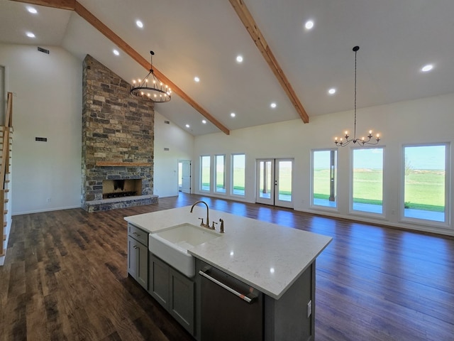 kitchen featuring decorative light fixtures, a chandelier, beamed ceiling, and high vaulted ceiling