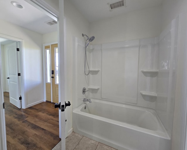 bathroom featuring shower / bath combination and tile patterned flooring