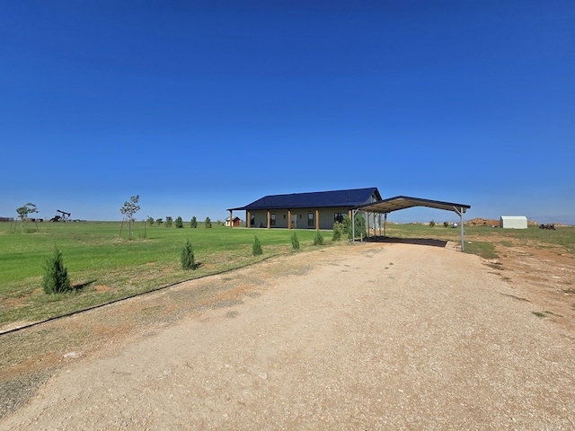 view of front facade with a rural view and a front yard