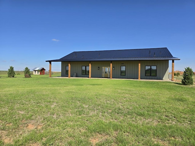 back of property featuring a lawn