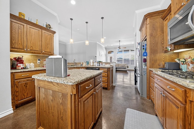 5712 Carmel Ct, Midland, TX 79707 - kitchen featuring appliances with stainless steel finishes, a kitchen island, brown cabinetry, backsplash, and ornamental molding