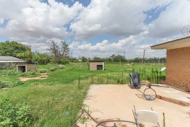 207 W Robinson Rd, Big Spring, TX 79720 - view of yard featuring a storage shed and a patio area