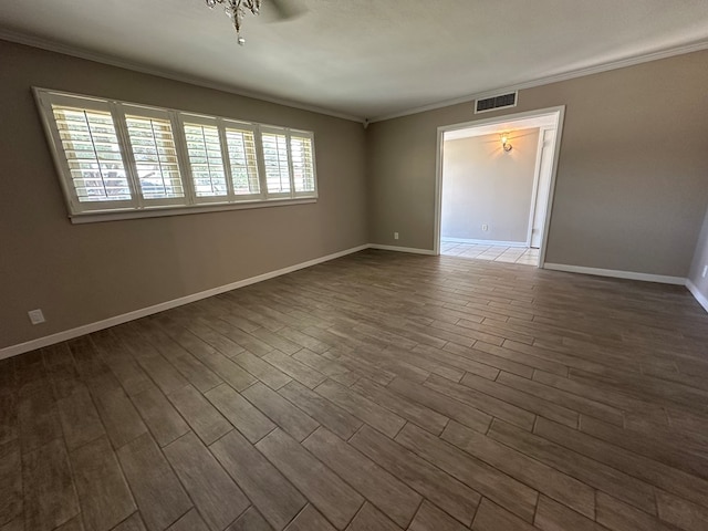 empty room featuring wood-type flooring, ceiling fan, and crown molding