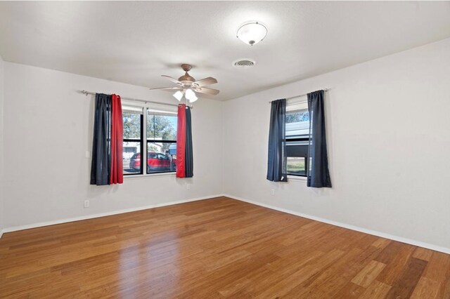 unfurnished room featuring hardwood / wood-style flooring and ceiling fan