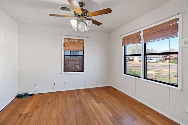 spare room with light wood-type flooring and ceiling fan